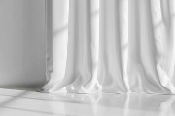 A simple white curtain hangs in a room with a window, providing a clean backdrop