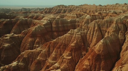 Aerial view of a canyon in the desert with sandstone cliffs and rocky formations