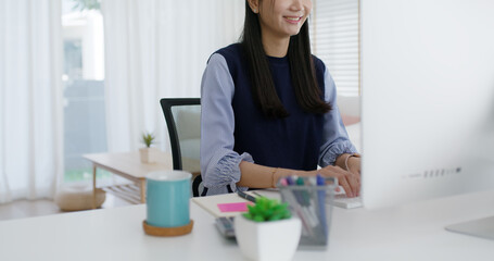 Young lady asia people teen girl talent workforce remote work at home office workspace sit relax on desk table. Distant job digital learn online reskill upskill career coding class chat on desktop PC.