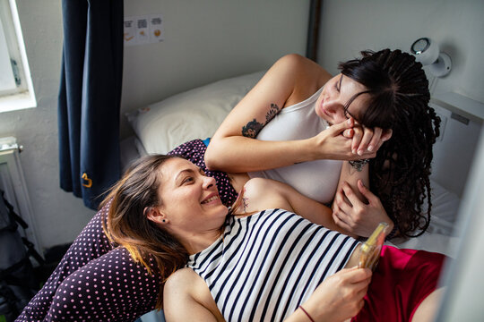 Friends hanging out in a modern hostel dorm room