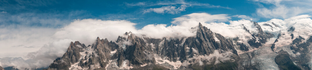 Panoramic View Of The Mont Blanc Massif With Its Peaks Partially Covered By Clouds