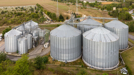 Aerial view of agricultural Silos. Storage and drying of grains, wheat, corn, soy, sunflower. Elevator silos © dechevm