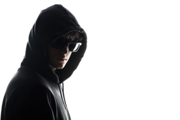 Mysterious man in hoodie and sunglasses on dark background, exuding an enigmatic and secretive aura.