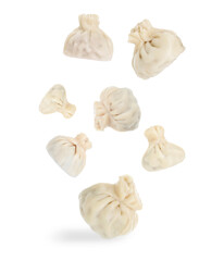 Delicious khinkali (Georgian dumplings) falling on white background
