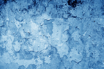 Peeling paint on grungy plaster wall. Blue style.