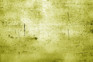 Scratched and weathered metal plate surface. Yellow toned