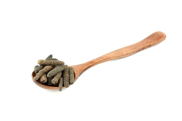 Wooden spoon full Long pepper or Pippali pepper on a white background.