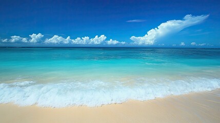 Obraz premium A breathtaking Caribbean beach scene, with turquoise waves gently lapping against the shore, under a cloudless blue sky.
