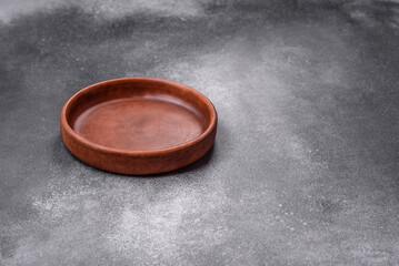 Empty ceramic plate on a dark textured background