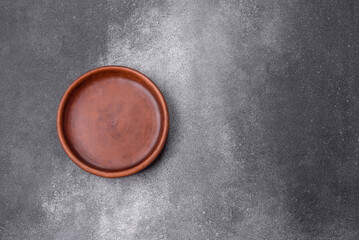 Empty ceramic plate on a dark textured background
