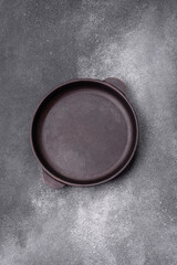 Empty ceramic plate on a dark textured background