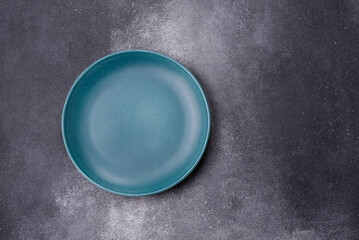 Empty ceramic plate on a dark textured background