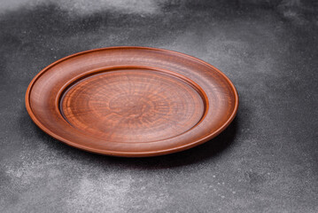 Empty ceramic plate on a dark textured background