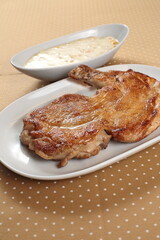 Grilled Capon Chicken with Creamed Corn on the plate