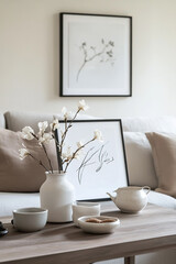 A picture frame displaying elegant line art sits on a coffee table in a stylish living room