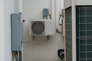 Air compressor or air condenser unit located on support outside building to heat released...