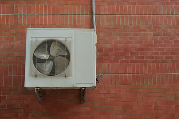 Air compressor or air condenser unit located on support outside building to heat released...