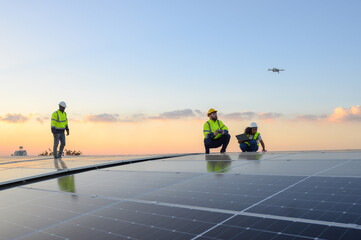 A team of engineers flies a drone to plan the installation of an outdoor solar panel system. Installing solar cells on the roof Solar panels on the roof Workers install eco-technology solar power plan © eakarat