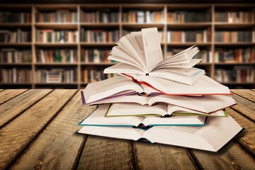 pile of reading books on table in library, education