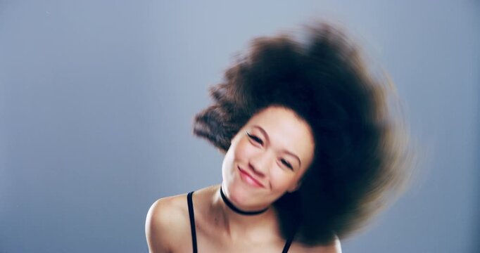 Dancing music, studio face and happy woman energy, smile and having fun at party, concert or festive event. Freedom, wellness and portrait dancer, afro model or celebration girl on gray background