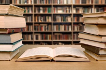 pile of reading books on table in library, education