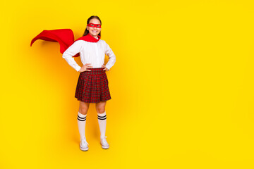 Full size photo of charming teen pupil girl confident superhero wear trendy uniform isolated on yellow color background