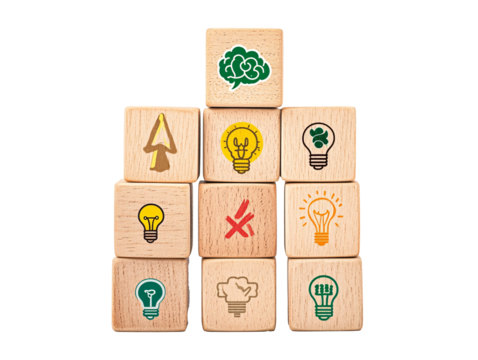 a stack of wooden cubes with light bulbs and symbols