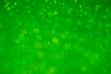 Naklejka premium A green background with many small green shapes. The shapes are all different sizes and are scattered throughout the background