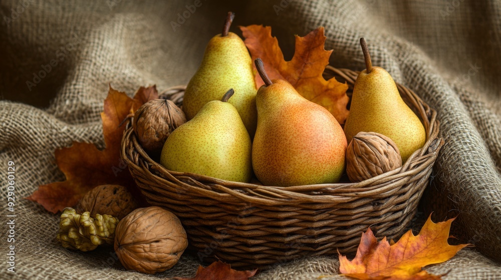 Poster a basket filled with fresh pears and walnuts surrounded by colorful autumn leaves on a burlap surfac