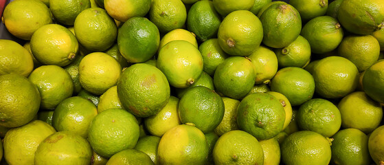 The close-up photo showcases a vibrant, fresh lemon with its glossy, textured skin. The fruit's bright yellow color highlights its richness in vitamins, exuding freshness and zest against a soft backg
