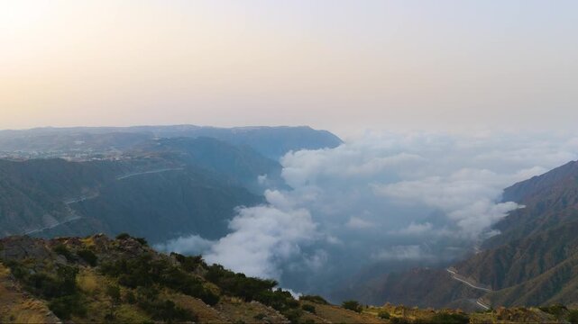 Stunning 4K drone footage of the Sarawat Mountains in Baha, Saudi Arabia. Capture the dramatic contrast of verdant peaks against a backdrop of swirling clouds. Ideal for travel, nature, and cinematic 