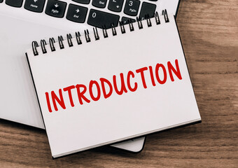 Red Introduction Word On White Notebook With Laptop Keyboard