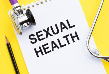 Stethoscope and Pencil Resting on a Notepad With the Words Sexual Health Written in Black