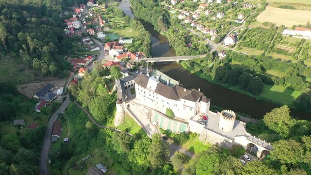 Aerial video captures Ceski Sternberk Castle atop a lush, wooded hill, amazing, fairytale