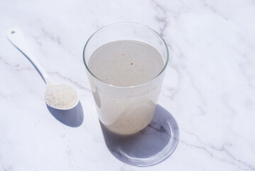 A glass of water soluble psyllium husk dietary fiber supplement