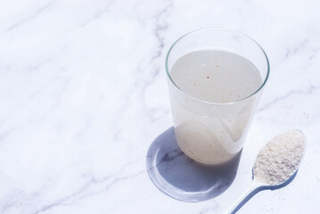 A glass of water soluble psyllium husk dietary fiber supplement