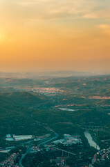Top view of sunset over rural village and mountain range horizon