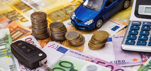 Small toy car with keychain on Eur banknotes. Money for sale rent or insurance