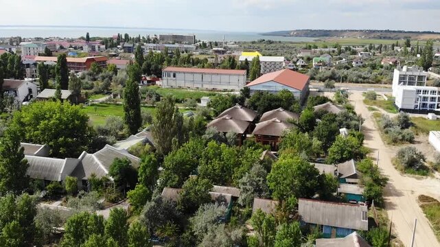 Aerial drone view from above of sandy beach and Black sea in Zatoka resort, Karolino-Bugaz, Odessa region, Ukraine. Hotels and apartments, architectural complex and houses. Summer holiday in Europe. 
