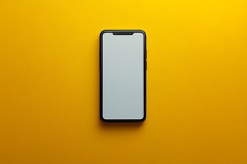  A modern smartphone with a sleek black frame and a blank white screen is displayed against a vibrant yellow background. The phone is centered and viewed from above, emphasizing its minimalist design 