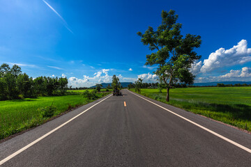 Fototapeta premium Nature Wallpaper (Mountains, Green Fields, Roadside Accommodation, Twilight Sky) The beauty of nature while traveling, with the wind blowing through the blurred leaves.