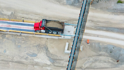 Aerial View of Red Dump Truck on Weighbridge at Industrial Quarry © Nicholas J. Klein