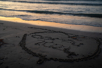 inscription on the sand Corfu 2024 at sunset