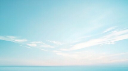 Fototapeta premium Serene Sky: A calming and ethereal image with a soft gradient of blue and white, featuring a vast expanse of sky with wispy clouds, evoking a sense of peace and tranquility. 
