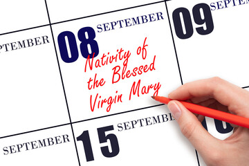 September 8. Hand writing text Nativity of the Blessed Virgin Mary on calendar date. Save the date.