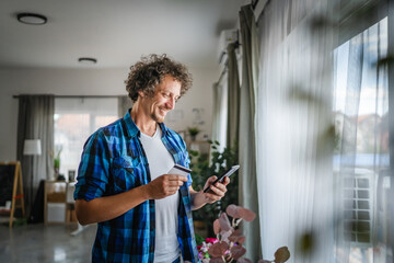 adult man have online shopping on mobile phone with credit card