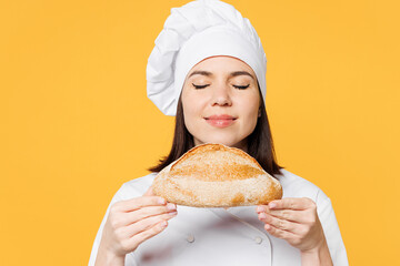 Close up young chef cook baker woman wear white shirt black apron uniform toque chefs hat hold big...