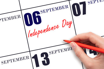 September 6. Hand writing text Independence Day on calendar date. Save the date.