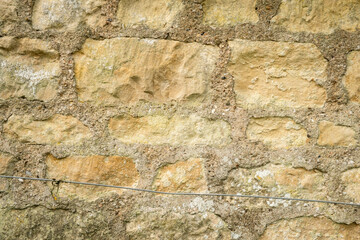 Rustic Stone Wall Background with Weathered Texture and Visible Mortar Details