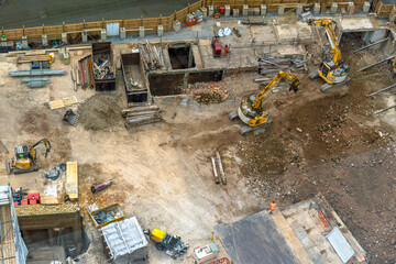 Aerial view of a construction site and building site with heavy machinery in operation in London's...